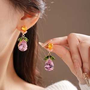 Detail of leaf-shaped earrings featuring pink and green pear-cut colorful zircons