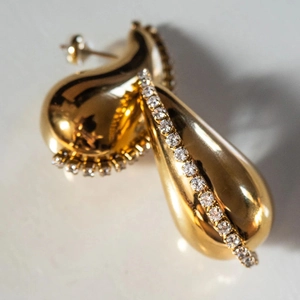 Macro shot of 18K gold plated stainless steel teardrop earrings with cubic zirconia inlay