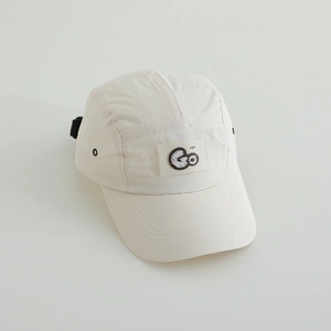 Detail of cream five-panel baseball cap with Go embroidery and metal ventilation eyelets