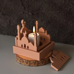 Detailed view of Middle Eastern castle candle holder with glowing candle on wood