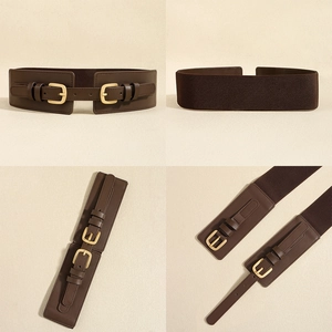 Detail view of dark brown elastic wide belt with golden double buckles and leather finish
