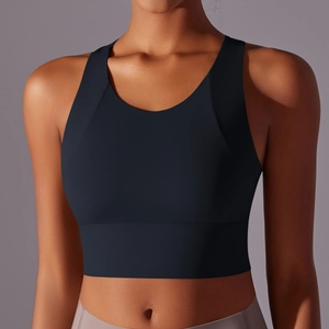 Detail view of navy high-neck sports bra with wide straps and seamless compression fabric