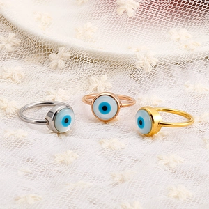 Macro view of three Evil Eye rings in silver, rose gold and gold plating on lace