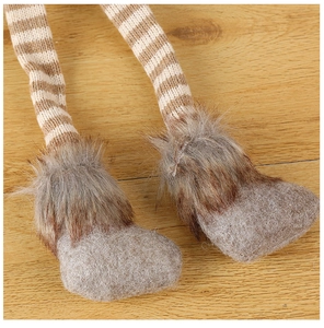 Detail of striped knit legs and faux fur trim on a Christmas plush reindeer doll
