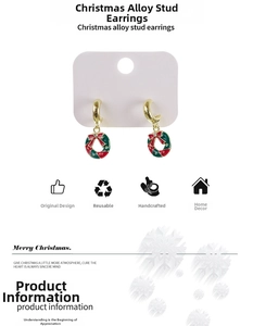 Detail of Christmas wreath stud earrings with red bow and sparkling cubic zirconia