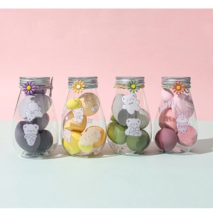 Four sets of colorful makeup sponges in daisy jars, including tear-drop and gourd shapes