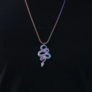 Macro view of a creative rainbow steel snake pendant with matching metallic chain