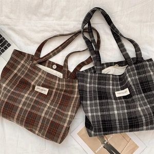 Detailed top view of retro plaid wool tote bags featuring metal magnetic buckles