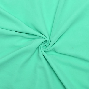 Close-up of soft mint green chiffon fabric with elegant pleated swirl texture details