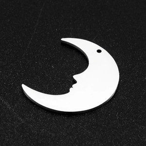 Macro shot of silver crescent moon face charm made of stainless steel for DIY jewelry