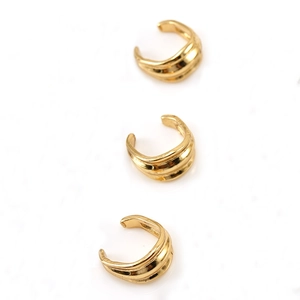 Detailed view of three 18K gold-plated stainless steel multilayer wavy ear cuffs