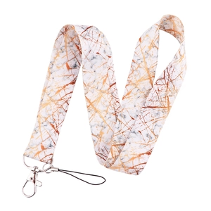 Close-up of fabric phone lanyard with white marble and gold vein pattern and metal clasp