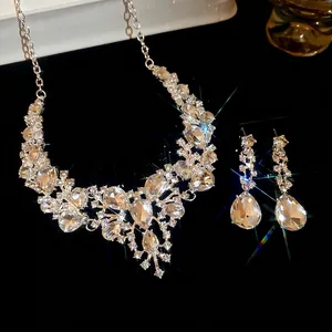 Elegant silver teardrop crystal necklace and earrings jewelry set for women on black base