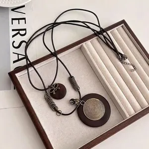 Bohemian retro long necklace with round wood pendant and gold metal spiral details
