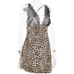 Detail of leopard print dress featuring deep V-neck with black lace trim and satin fabric