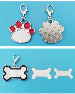 Close-up of DIY heat transfer pet ID tags in bone and paw shapes with lobster clasps