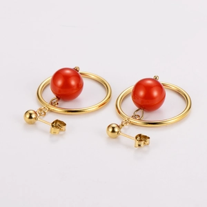 Vintage stainless steel hoop earrings with elegant red bead pendants on white background