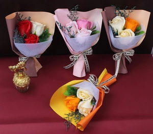 Detail view of colorful soap rose bouquets in premium packaging with ribbons and mesh