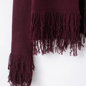 Women's burgundy knit cardigan with bohemian fringe tassels on sleeves and hemline