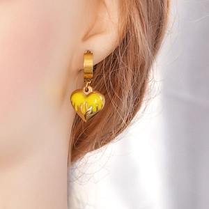 Polished gold heart pendant with yellow enamel oil drip on minimalist hoop earrings