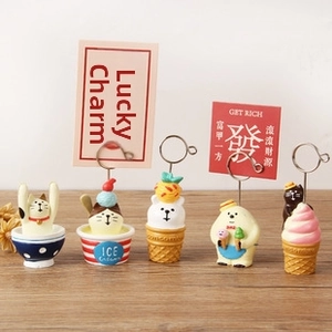 Close-up of cute animal resin memo clips on a wooden table with ice cream designs