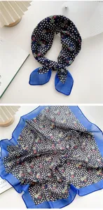 Detailed view of floral cotton linen scarf with blue border and vibrant flower pattern
