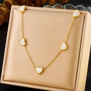 Golden stainless steel heart necklace featuring five white shell pendants in a gift box