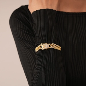 Close-up of iced out cuban link bracelet in 18K gold with shimmering zircon stones