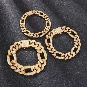 Close-up of three gold iced-out Cuban link bracelets with pavé rhinestones in hip hop style