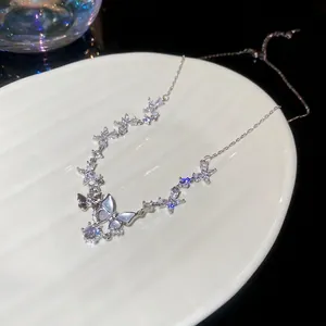 Exquisite zircon butterfly pendant necklace with iridescent wings on a white ceramic plate