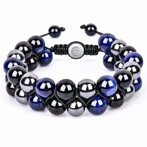 Detailed macro view of 10mm lava stone beads and magnetic hematite in hand-woven bracelet