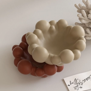 Close-up of cloud bubble resin jewelry trays in matte beige and terracotta finishes