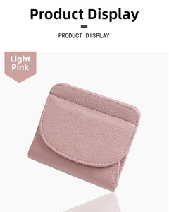 Detail view of light pink lychee texture leather wallet with fine stitching and soft finish