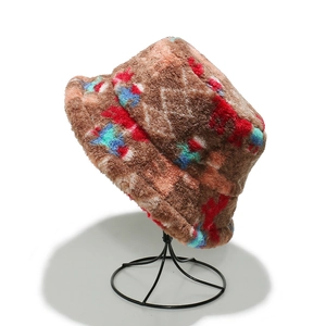 Close-up of colorful faux fur bucket hat with bohemian geometric pattern on metal stand