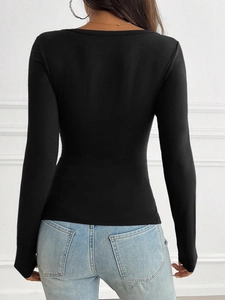 Back view of a chic black long-sleeve Y2K style t-shirt paired with light blue denim jeans