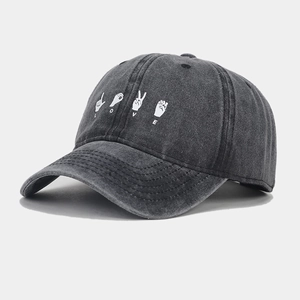 Detail of dark grey washed denim baseball cap featuring white LOVE sign language print
