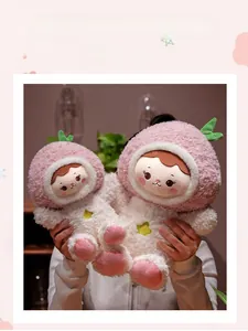 Detail of plush peach girl dolls in two sizes featuring pink fruit hoodies and soft white fur