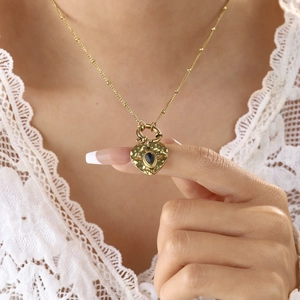 French vintage 18K gold plated heart necklace with black stone on white lace clothing