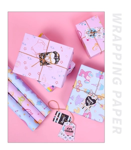 Detail view of newborn gift wrapping paper with baby shower patterns and matching gift tags