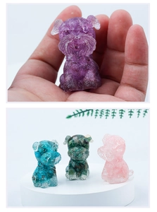 Close-up of colorful mini schnauzer crystal dog figurines held in hand and on display