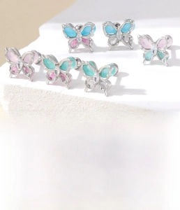 Detail of titanium steel butterfly studs with colorful zircon and 0.8x6mm screw back bar