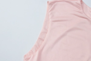 Detailed view of pink sleeveless dress showing shoulder straps and neat stitching
