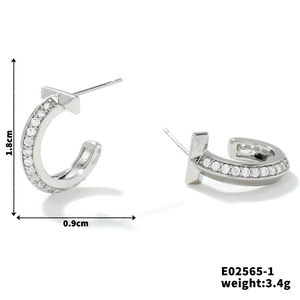 Macro detail of silver C-shaped semi-circle earrings with cubic zirconia and T-bar design