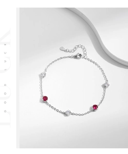 Close-up of S925 sterling silver chain featuring red and white zircon stones and lobster clasp