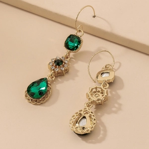 Detailed macro view of vintage green water-drop zircon flower drop earrings in gold