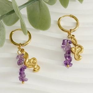 Gold 18k plated music note earrings with natural purple stone charms on white background