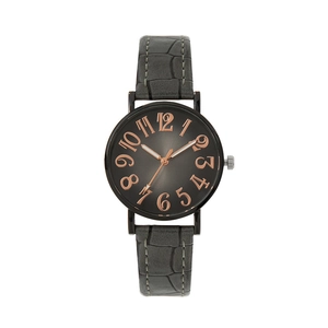 Gros plan d'une montre vintage pour femme avec cadran gris et grands chiffres dorés