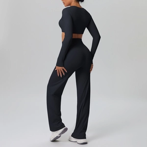 Detail view of black two-piece yoga set with long sleeve crop top and flared pants