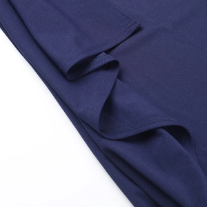 Detail of navy blue knit fabric showing professional stitching and smooth texture