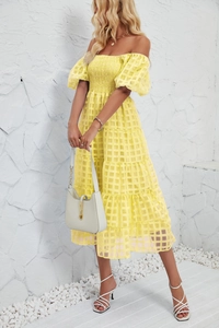 Detail of light yellow tiered summer dress with smocked bodice and puff sleeves